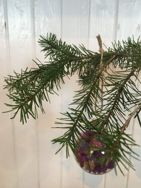 Glass ornament hanging on a branch